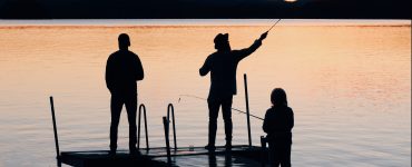 family fishing at sunset