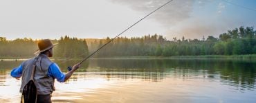 person fly fishing on a lake