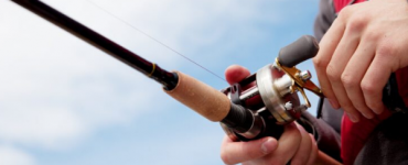 person fishing with a baitcaster reel