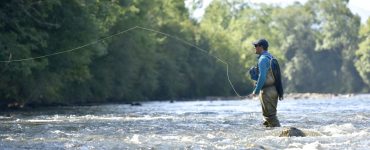 Flyfisherman fishing with sling pack