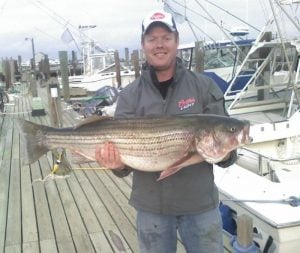 brian holding a big striped bass