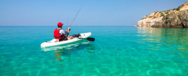 man fishing in a kayak with a fish finder