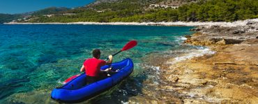 person in an inflatable kayak