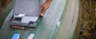 person repairing their kayak