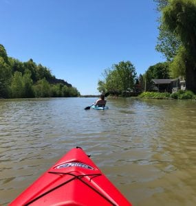 person paddling a pelican kayak