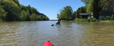 person paddling a pelican kayak
