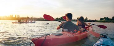 people in tandem kayaks