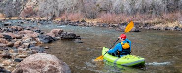 person in an inflatable kayak