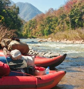 two inflatable kayaks on shore
