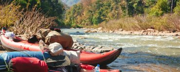 two inflatable kayaks on shore