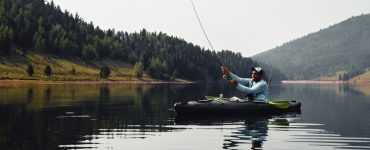 man fly fishing from a kayak