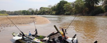 fishing kayak on the shore of a river