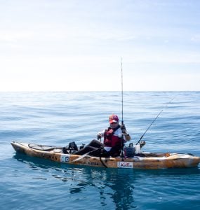 person fishing in the ocean on a kayak