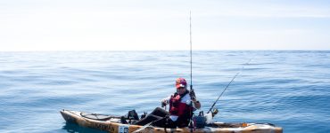 person fishing in the ocean on a kayak