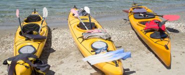 tandem fishing kayaks on the shore