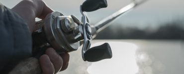 person fishing with a baitcaster combo