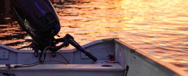 an outboard engine mounted on the back of a jon boat for fishing