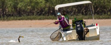 people fishing inshore on a boat