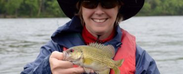 person holding a rock bass caught fishing