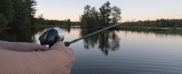 person fishing with a spincaster rod and reel combo