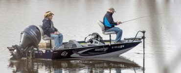 2 fishermen on a boat using a trolling motor