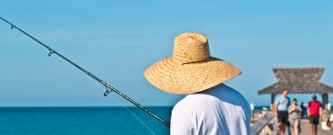 fisherman wearing a straw fishing hat